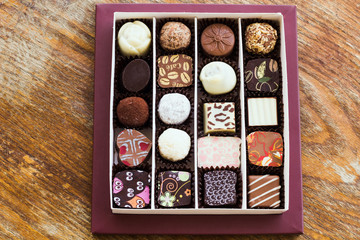 Assorted chocolate candies on a wooden table