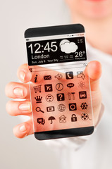 Obraz premium Smartphone with transparent screen in human hands.