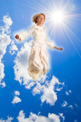 Obraz premium Jumping girl in cloudscape