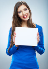 Teenager girl hold white blank paper. Young smiling woman show