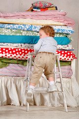 Child climbs on the bed - Princess and the Pea.