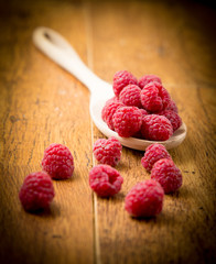 Raspberries on wooden spoon
