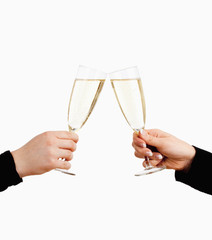 Two Hands Holding Glasses of Champagne Toasting