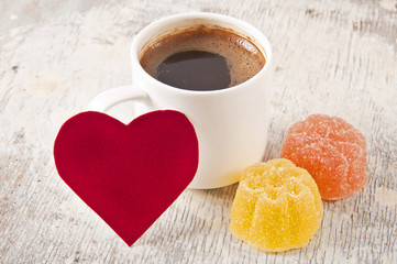 valentines and coffee cup on old wooden background