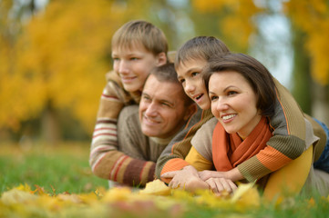 Fototapeta na wymiar Happy family in the autumn park