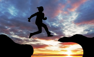 Woman jump over canyon