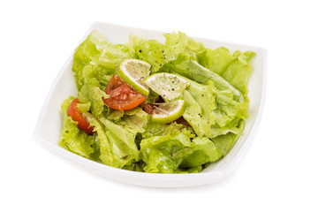 Plate with salad on white background