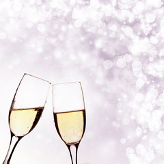 Two glasses of champagne on brillante background