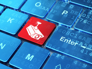 Privacy concept: Cctv Camera on computer keyboard background © Maksim Kabakou