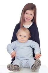 Loving girl taking care of her little brother