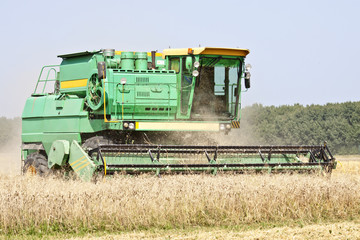 Harvester working in a wheat field