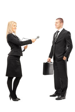 Young Female Interviewer Talking To Male Businessman