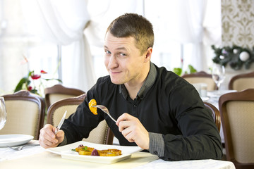 young man having dinner in a restaurant