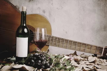 Fotobehang Eetkamer Still life of red wine bottle and wine glass with acoustic guita  © kromkrathog