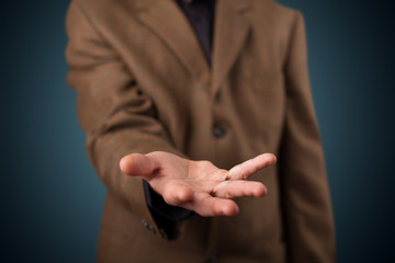 Handsome business man presenting with hand copy space