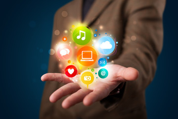 Young businessman presenting colorful technology icons and symbo