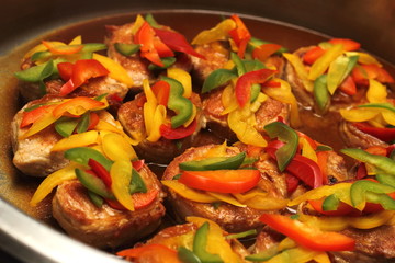 Roast beef topped with green peppers, yellow, red.