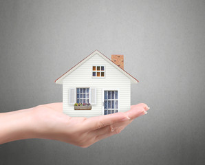 holding house representing home ownership