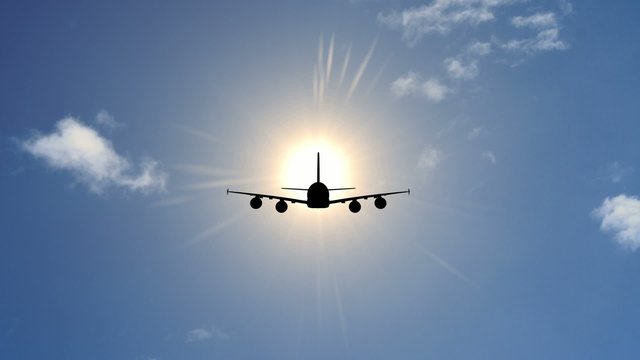 Airplane in Sky With Sun