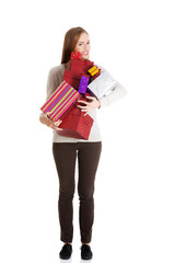 Beautiful casual woman holding presents in boxes.