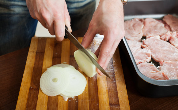 Hands cutting onion