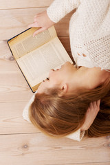Fototapeta na wymiar Young beautiful woman lying on the floor with books.