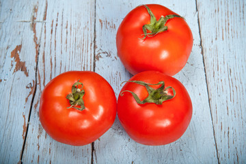 three tomatoes on a plaid towel