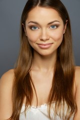 Beautiful girl with long hair isolated on grey