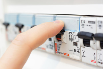 man turning on the fusebox