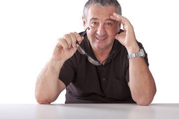 Gray-haired man with glasses sitting at the table