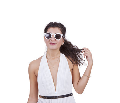 Attractive woman wearing sunglasses against white