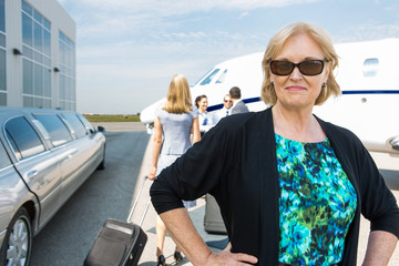 Confident Businesswoman Against Private Jet