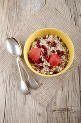 pomegranate seed with muesli in a bowl
