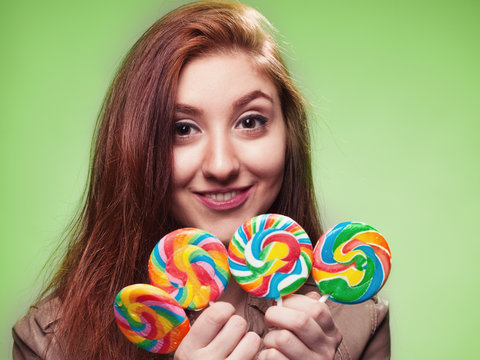 young girl with lollipop on a green
