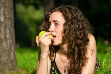 beautiful young woman eating apple