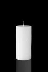 White candle isolated on dark background
