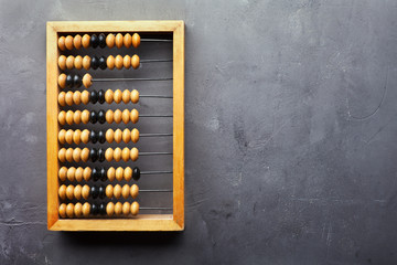 Accounting abacus on gray textured background - obrazy, fototapety, plakaty