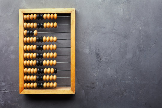 Accounting abacus on gray textured background