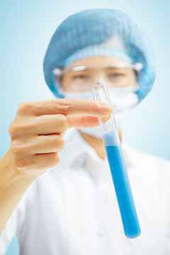 Laboratory assistant with blue test tube