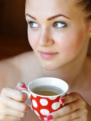 Beautiful woman holds the cup of tea