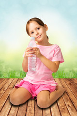 Cute little girl holding bottle of clear water