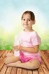 Cute little girl holding bottle of clear water