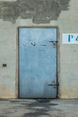 Closeup metal door with lock with wall graffiti