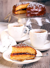 Layer spicy cake with jam and chocolate glaze