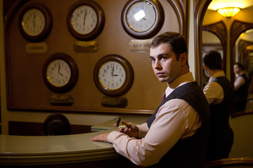 Serious businessman is sinchronizing his wath