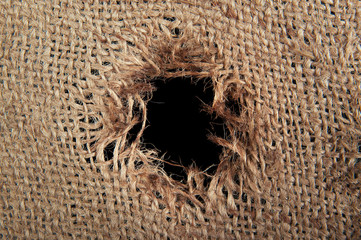 Torn burlap decayed. Ragged linen fabric.