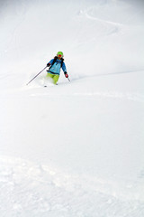 Skier in deep powder, extreme freeride