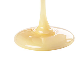 Pouring condensed milk on white background