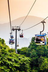 Aerial tramway moving up in tropical jungle mountains © 06photo