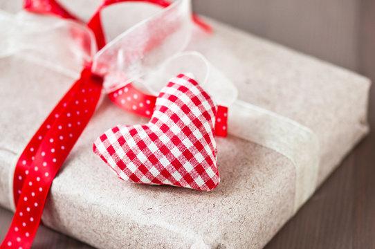 Homemade red heart and gift with red ribbon